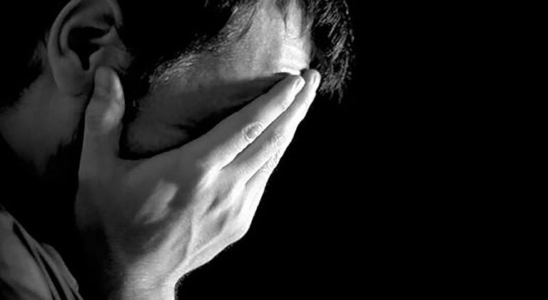 Person feeling overwhelmed while seeking mental health and emotional support